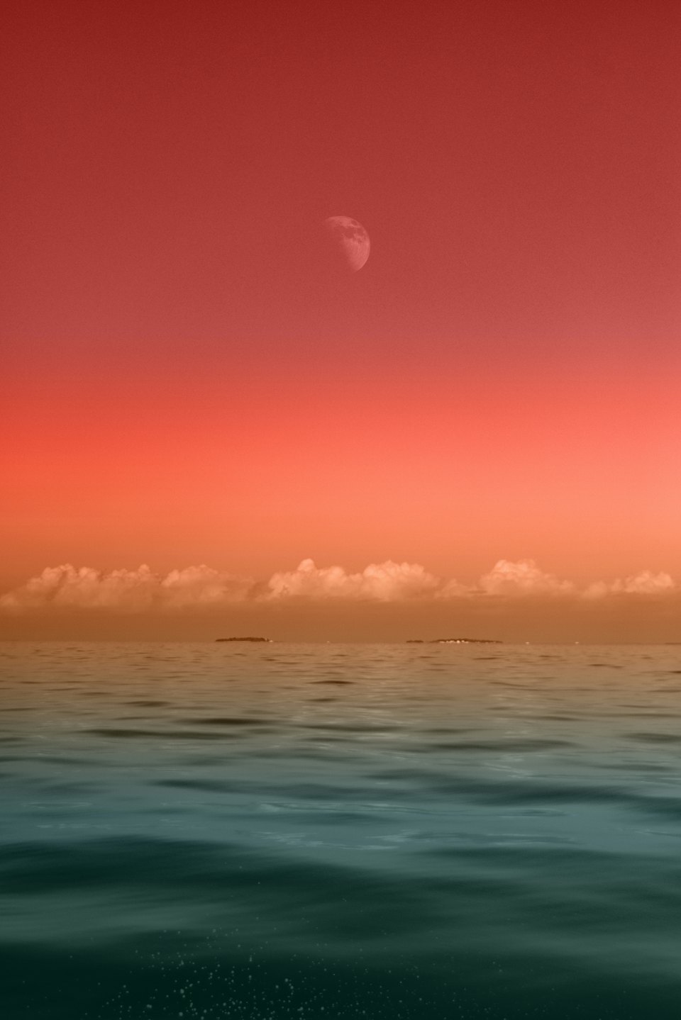 Open sea at dusk under a deep red sky with a rising moon.